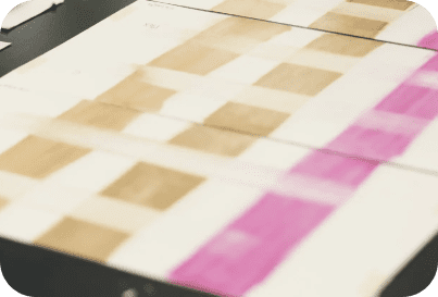 A blurry image of a floor with pink and brown squares.